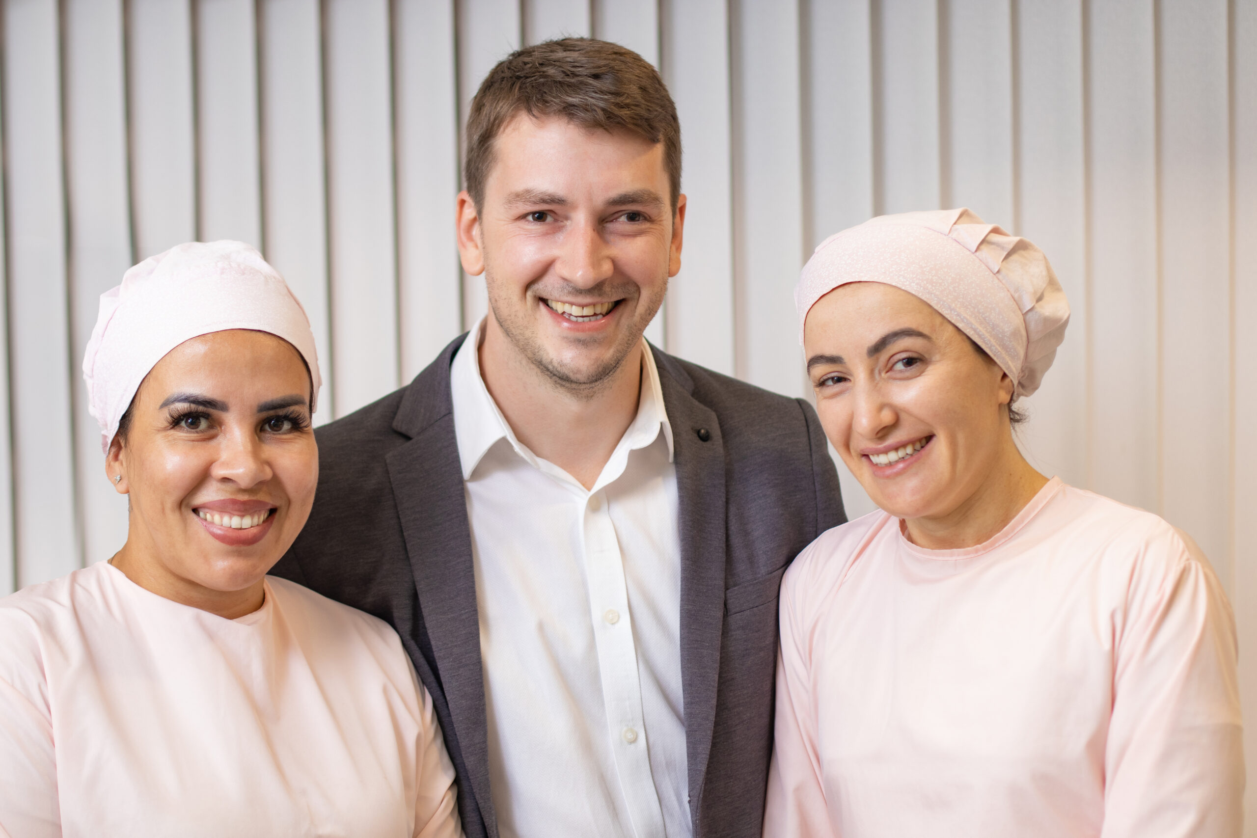 Dr. Timótio Dorn ao lado da equipe da clínica, reunidos em ambiente de atendimento com expressão acolhedora e profissional.
